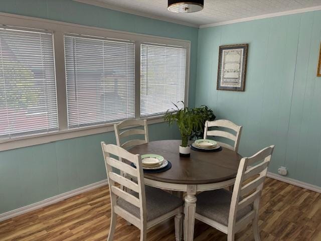 330 2nd St S, Shelby, MT 59474 - dining area featuring wood finished floors, plenty of natural light, baseboards, and crown molding