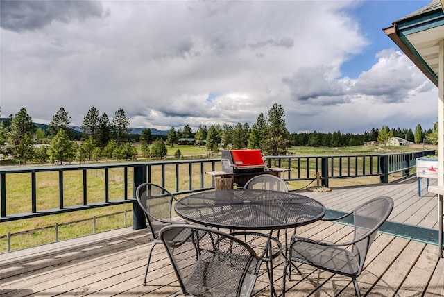 527 Grande Vista Dr, Kalispell, MT 59901 - deck featuring outdoor dining area and a lawn