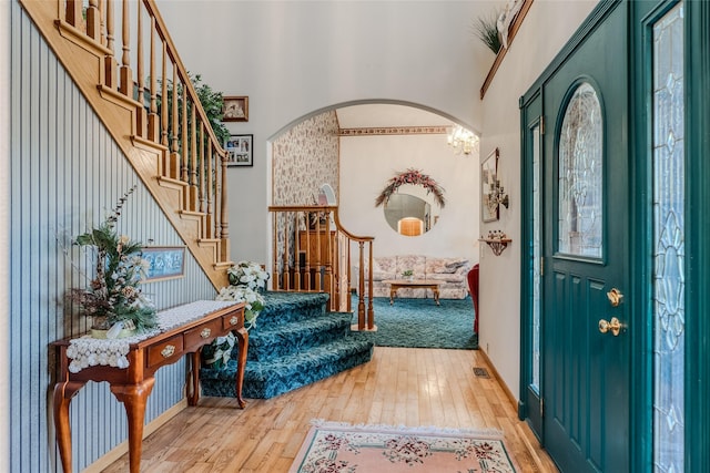 527 Grande Vista Dr, Kalispell, MT 59901 - entryway with hardwood / wood-style floors, stairs, arched walkways, a towering ceiling, and a chandelier