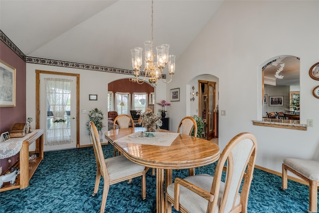 527 Grande Vista Dr, Kalispell, MT 59901 - dining area with arched walkways, vaulted ceiling, dark colored carpet, a chandelier, and baseboards