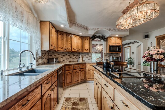 527 Grande Vista Dr, Kalispell, MT 59901 - kitchen featuring black appliances, a sink, arched walkways, a chandelier, and backsplash