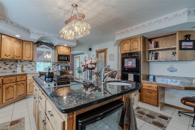 527 Grande Vista Dr, Kalispell, MT 59901 - kitchen with black appliances, beverage cooler, a sink, an island with sink, and arched walkways
