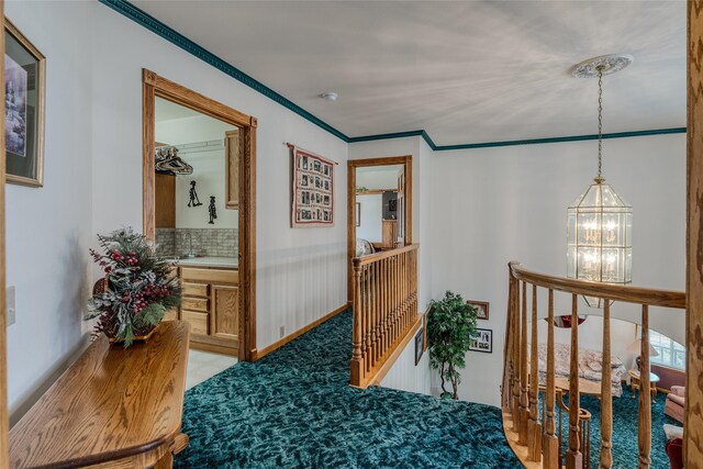 527 Grande Vista Dr, Kalispell, MT 59901 - corridor featuring an upstairs landing, a chandelier, and ornamental molding