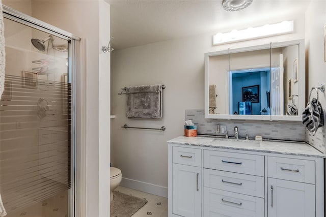 527 Grande Vista Dr, Kalispell, MT 59901 - full bathroom with decorative backsplash, a stall shower, vanity, toilet, and tile patterned floors