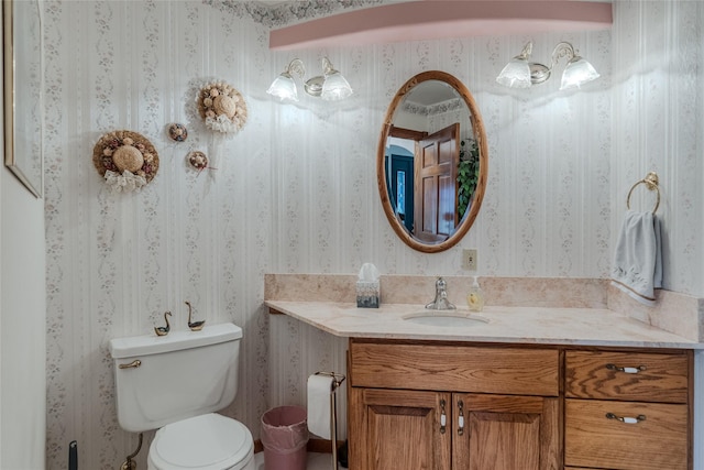 527 Grande Vista Dr, Kalispell, MT 59901 - half bath with wallpapered walls, toilet, and vanity