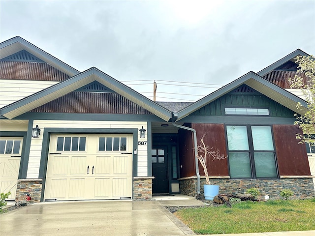687 Road Runner St Unit B, Helena, MT 59602 - craftsman house featuring stone siding, an attached garage, and driveway