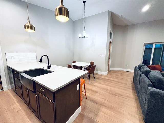 687 Road Runner St Unit B, Helena, MT 59602 - kitchen featuring a sink, light wood finished floors, open floor plan, and light countertops