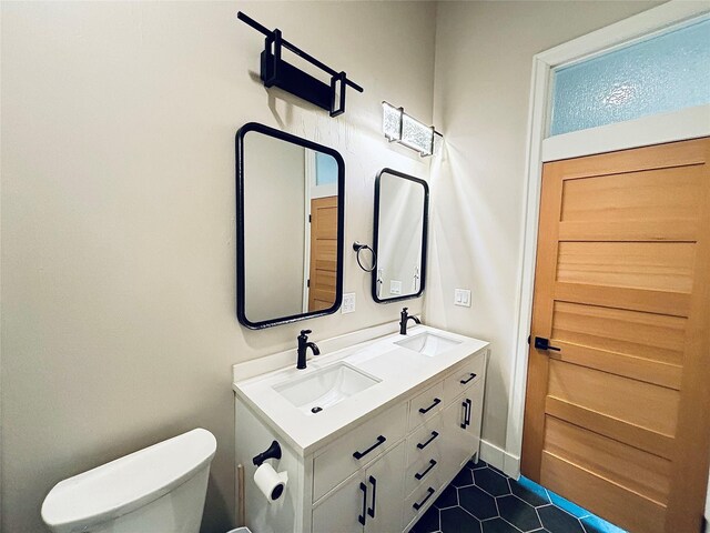 687 Road Runner St Unit B, Helena, MT 59602 - bathroom featuring toilet, double vanity, and tile patterned floors