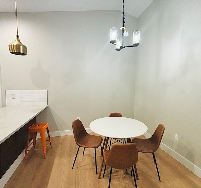 687 Road Runner St Unit B, Helena, MT 59602 - dining space with light wood-type flooring, baseboards, a chandelier, and lofted ceiling