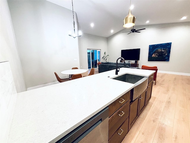 687 Road Runner St Unit B, Helena, MT 59602 - kitchen with lofted ceiling, pendant lighting, open floor plan, light wood finished floors, and light countertops