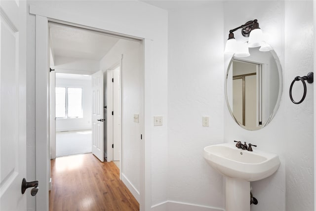 2060 Marina Ct, Bigfork, MT 59911 - bathroom with wood finished floors, baseboards, and a sink