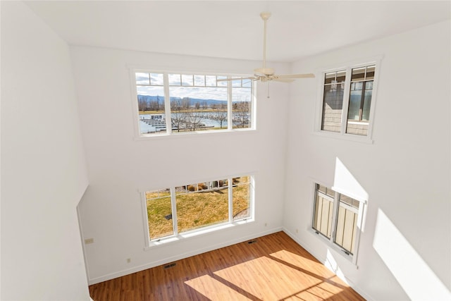 2060 Marina Ct, Bigfork, MT 59911 - entryway with wood finished floors, baseboards, a ceiling fan, a water view, and a towering ceiling