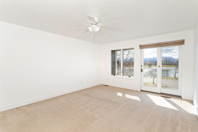 2060 Marina Ct, Bigfork, MT 59911 - spare room featuring baseboards, light colored carpet, and ceiling fan