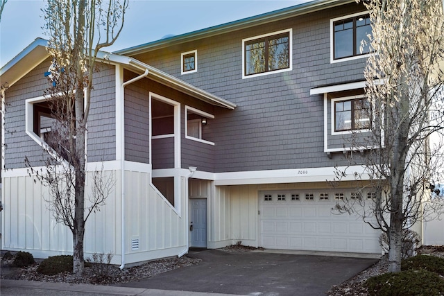 2060 Marina Ct, Bigfork, MT 59911 - view of front of property featuring driveway, board and batten siding, and an attached garage