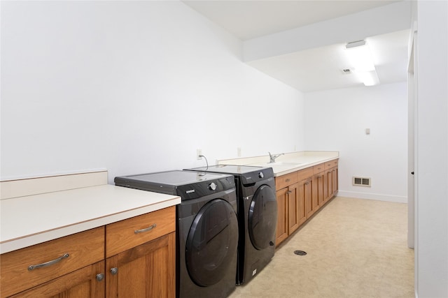2060 Marina Ct, Bigfork, MT 59911 - clothes washing area with independent washer and dryer, light colored carpet, cabinet space, and baseboards