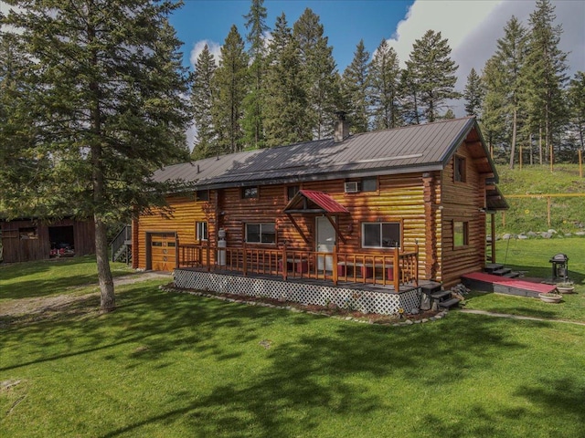 6470 US Highway 93 S, Eureka, MT 59917 - rear view of house with a wooden deck, a lawn, a garage, and log exterior