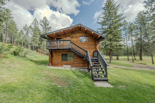 6470 US Highway 93 S, Eureka, MT 59917 - back of house with stairway, log siding, a yard, and a wooden deck