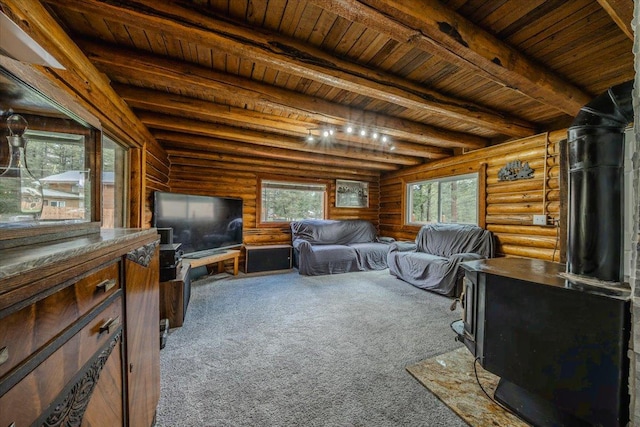 6470 US Highway 93 S, Eureka, MT 59917 - carpeted living room featuring a wood ceiling with exposed beams, a wood stove, and log walls