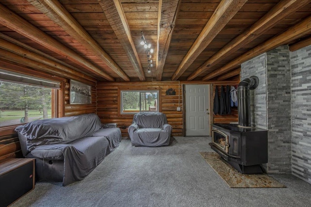 6470 US Highway 93 S, Eureka, MT 59917 - carpeted living room with a wood ceiling with exposed beams, rustic walls, and a wood stove
