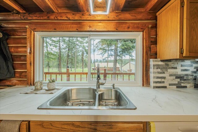 6470 US Highway 93 S, Eureka, MT 59917 - kitchen with wood ceiling, plenty of natural light, light countertops, brown cabinets, and rustic walls