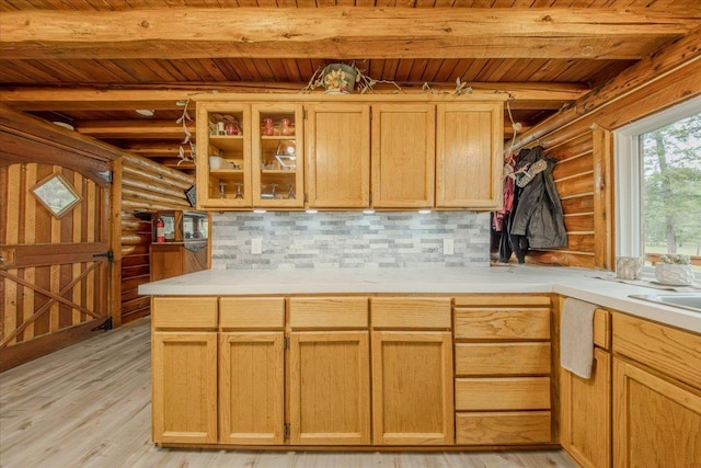 6470 US Highway 93 S, Eureka, MT 59917 - kitchen featuring rustic walls, a wooden ceiling with exposed beams, light wood-style flooring, tasteful backsplash, and light countertops