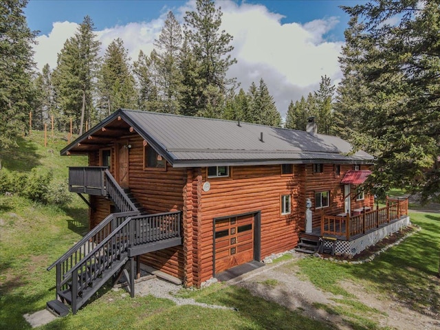 6470 US Highway 93 S, Eureka, MT 59917 - rear view of house featuring log siding, stairway, a wooden deck, dirt driveway, and a yard