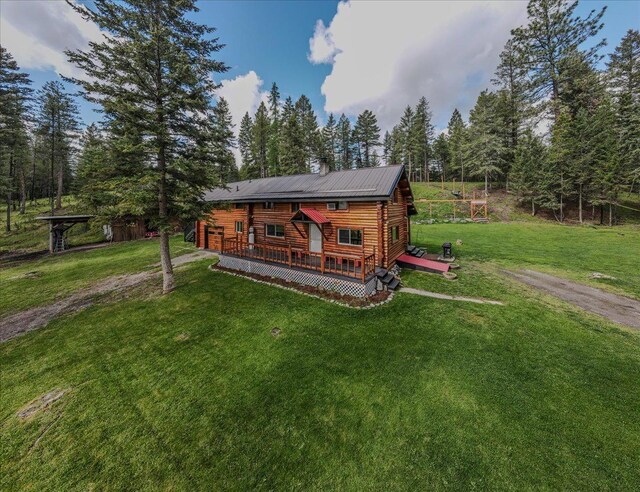 6470 US Highway 93 S, Eureka, MT 59917 - back of property with a deck, a yard, and a chimney