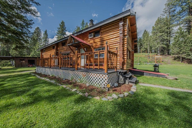 6470 US Highway 93 S, Eureka, MT 59917 - back of property with log siding, a deck, and a lawn