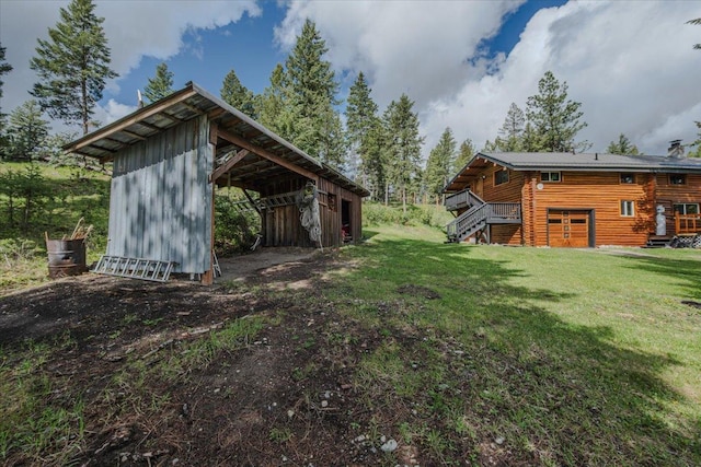 6470 US Highway 93 S, Eureka, MT 59917 - view of grassy yard with an outbuilding, stairs, and a deck