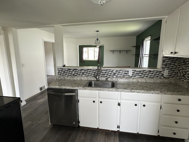 kitchen featuring dishwasher, a sink, white cabinets, and tasteful backsplash