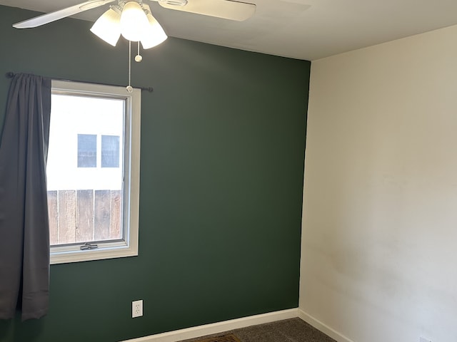unfurnished room with healthy amount of natural light, ceiling fan, and baseboards