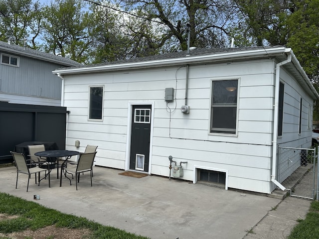 rear view of property with a patio and fence