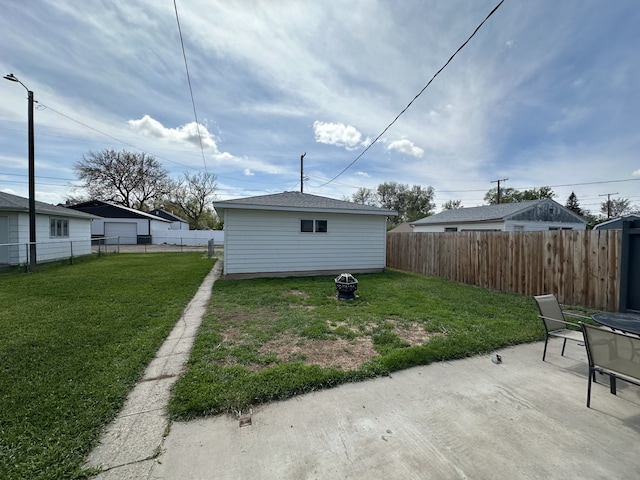 view of yard with a patio area, a garage, and driveway