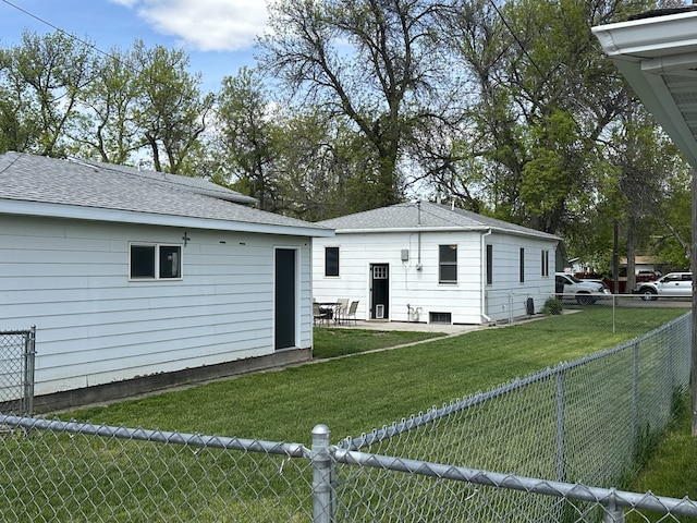 rear view of house featuring a shingled roof