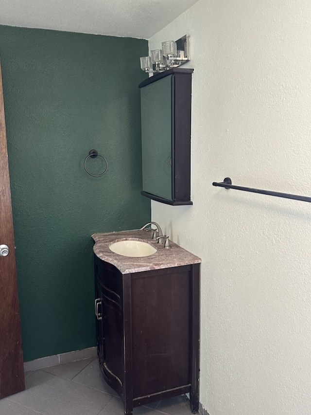 bathroom featuring tile patterned floors, vanity, and baseboards
