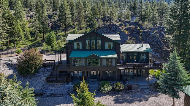6961 Mt Highway 200, Plains, MT 59859 - rear view of property with stairs, a deck, a forest view, a patio, and metal roof