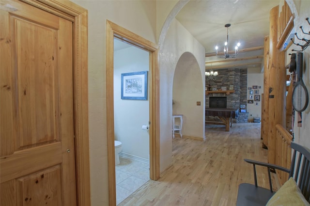 6961 Mt Highway 200, Plains, MT 59859 - corridor with a chandelier, light wood-style flooring, and arched walkways