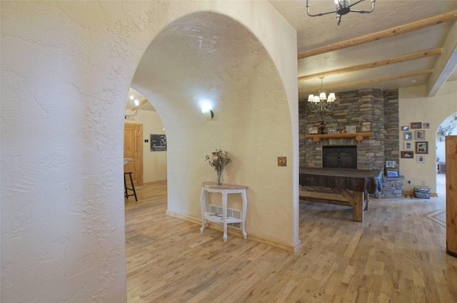 6961 Mt Highway 200, Plains, MT 59859 - hall featuring a chandelier, arched walkways, wood finished floors, and beamed ceiling