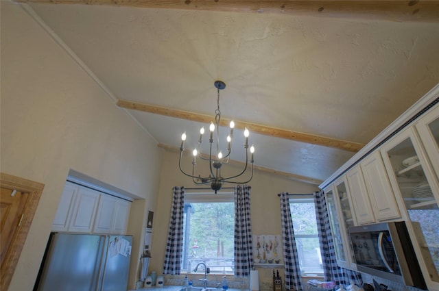 6961 Mt Highway 200, Plains, MT 59859 - detailed view of freestanding refrigerator, a chandelier, stainless steel microwave, a sink, and beam ceiling