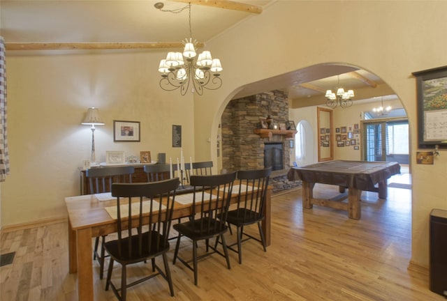 6961 Mt Highway 200, Plains, MT 59859 - dining space featuring arched walkways, a chandelier, light wood-style flooring, pool table, and lofted ceiling