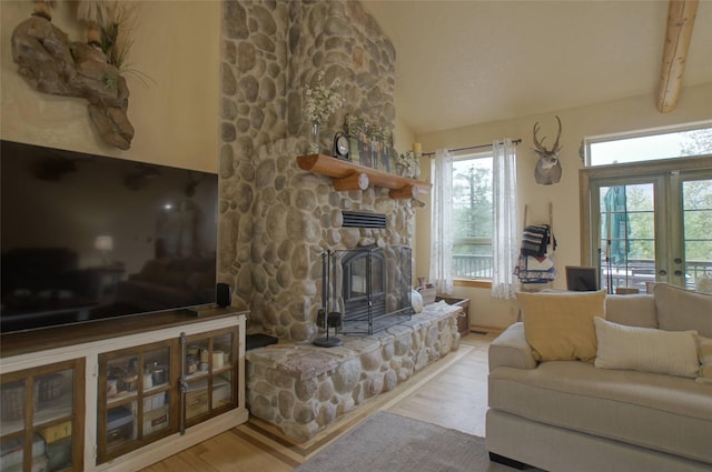 6961 Mt Highway 200, Plains, MT 59859 - living room featuring vaulted ceiling, wood finished floors, a fireplace, and french doors