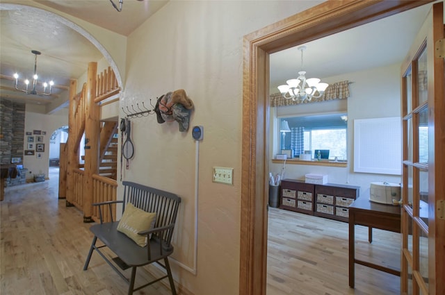 6961 Mt Highway 200, Plains, MT 59859 - hall featuring a chandelier, arched walkways, and wood finished floors
