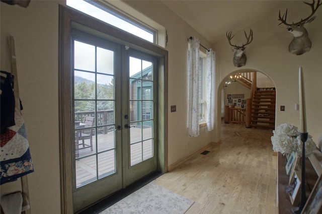 6961 Mt Highway 200, Plains, MT 59859 - entryway with french doors, arched walkways, stairway, and light wood-style floors