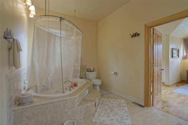 6961 Mt Highway 200, Plains, MT 59859 - full bathroom with tiled shower / bath combo, toilet, tile patterned floors, and baseboards