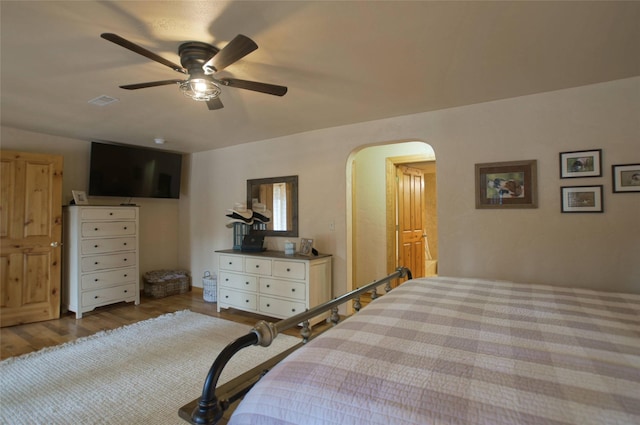 6961 Mt Highway 200, Plains, MT 59859 - bedroom featuring arched walkways, wood finished floors, and a ceiling fan