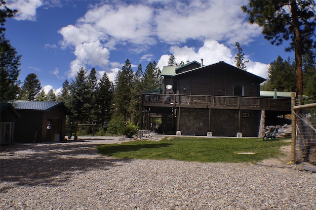 6961 Mt Highway 200, Plains, MT 59859 - back of house with a deck, metal roof, a lawn, and stone siding