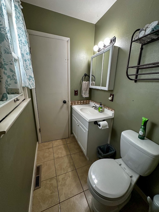 325 River Dr, Lolo, MT 59847 - bathroom with vanity, toilet, and tile patterned flooring