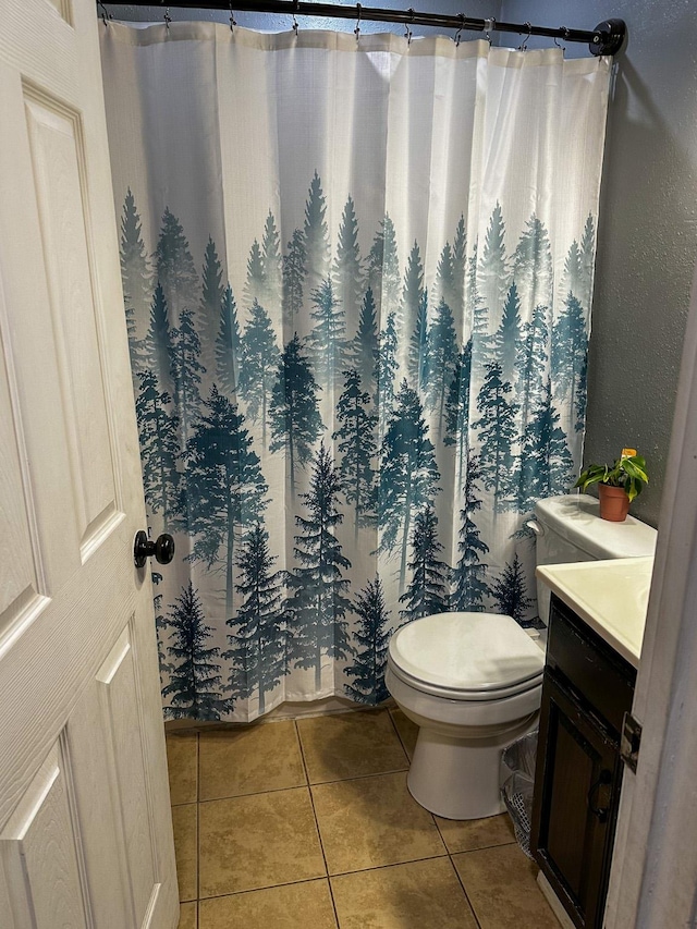 325 River Dr, Lolo, MT 59847 - full bath with tile patterned floors, vanity, toilet, and a shower with curtain