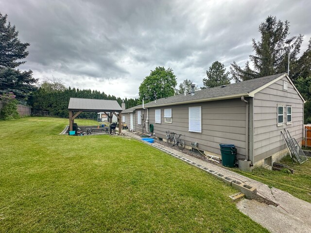 325 River Dr, Lolo, MT 59847 - back of property with a gazebo, a yard, and a patio