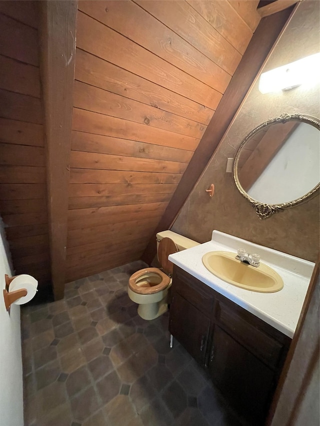 14 Sidehill Trl, Ennis, MT 59729 - bathroom featuring vanity, toilet, wooden ceiling, and lofted ceiling